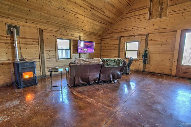 living room with a wood stove, wood ceiling, high vaulted ceiling, and wood walls