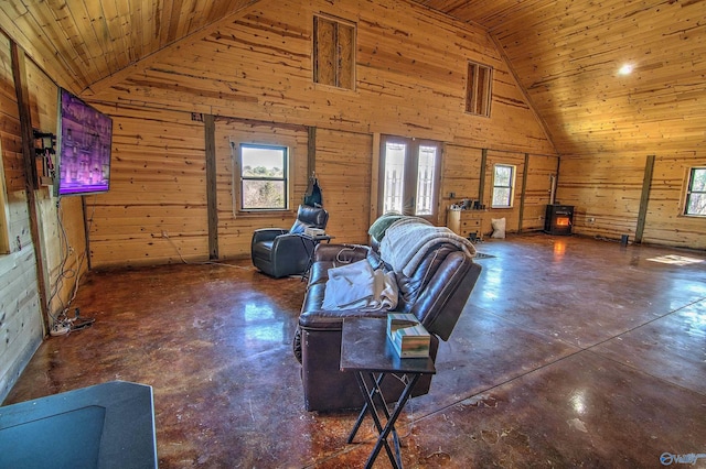 living room with wooden ceiling, a healthy amount of sunlight, and wood walls