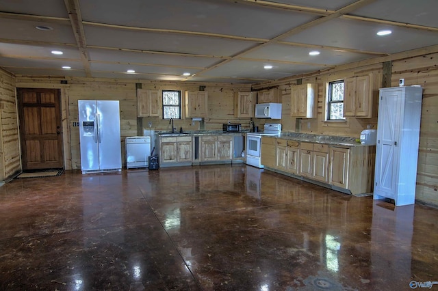 kitchen with light brown cabinetry, sink, white appliances, and plenty of natural light