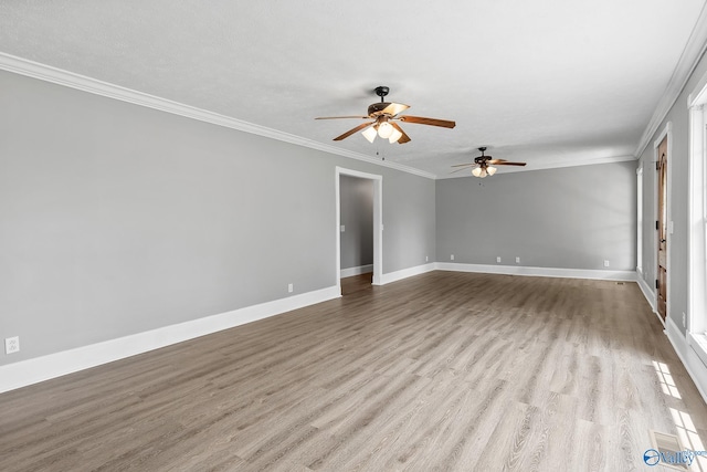 empty room featuring crown molding, a textured ceiling, light hardwood / wood-style flooring, and ceiling fan