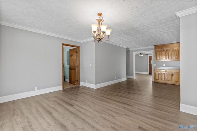 unfurnished living room with ornamental molding, a textured ceiling, ceiling fan with notable chandelier, and light wood-type flooring