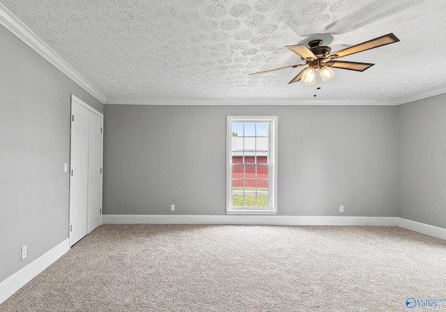 unfurnished room featuring ornamental molding, carpet flooring, a textured ceiling, and ceiling fan