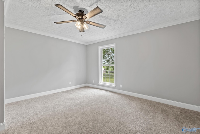 carpeted spare room with a textured ceiling, ceiling fan, and crown molding