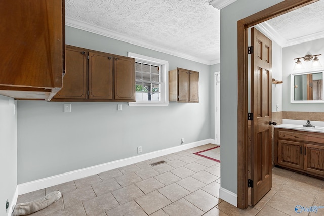 interior space featuring a textured ceiling, ornamental molding, and light tile patterned floors