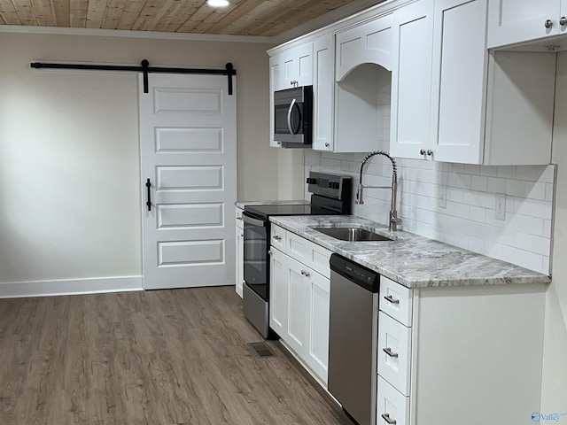 kitchen featuring wooden ceiling, stainless steel appliances, light stone countertops, and white cabinets