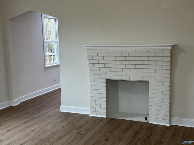 details with a brick fireplace and hardwood / wood-style floors