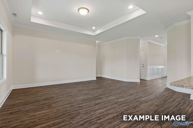 unfurnished room featuring crown molding, dark hardwood / wood-style floors, and a tray ceiling