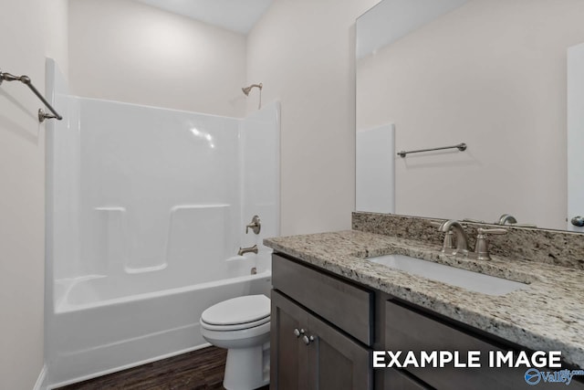 full bathroom featuring vanity, toilet, wood-type flooring, and shower / washtub combination