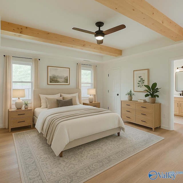 bedroom with beam ceiling, light wood-type flooring, ensuite bathroom, and multiple windows
