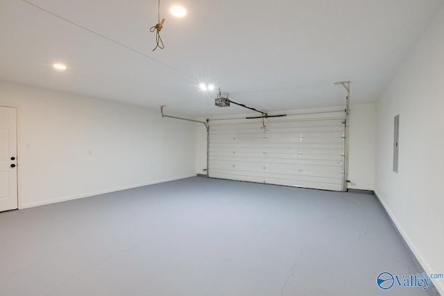garage with recessed lighting, electric panel, and baseboards