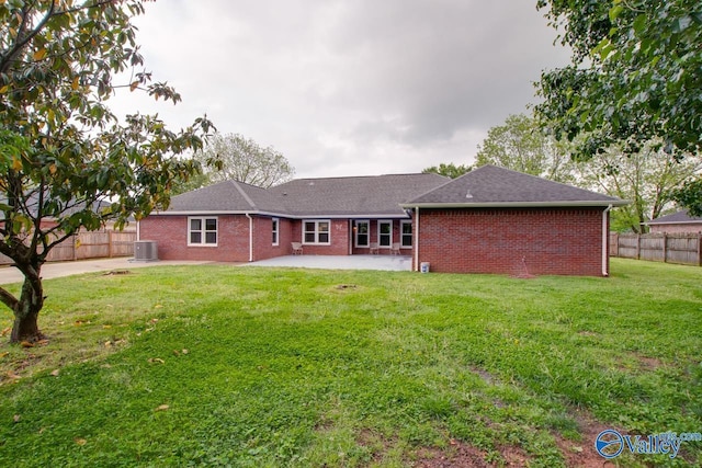back of house featuring fence, central AC, a patio, and brick siding