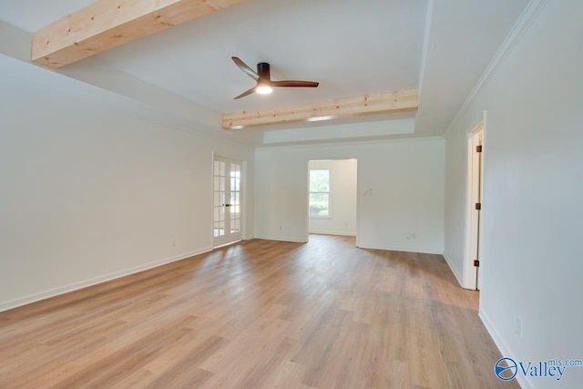 empty room featuring ceiling fan, baseboards, beam ceiling, and light wood-style floors