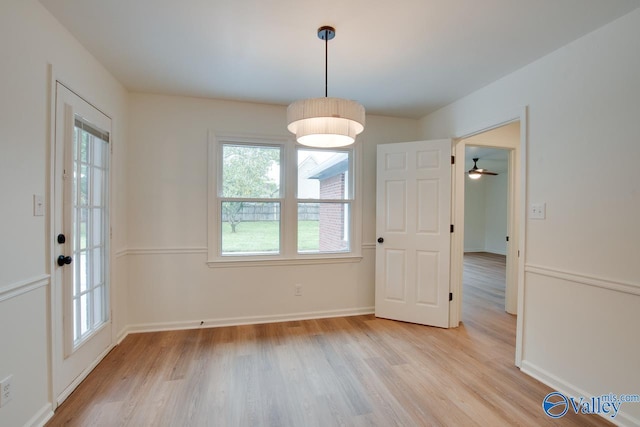 unfurnished dining area featuring baseboards, light wood-style floors, and plenty of natural light
