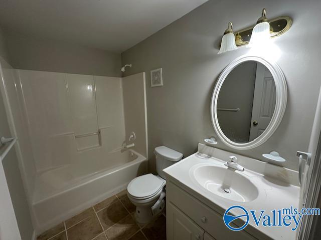 full bathroom featuring shower / bathtub combination, tile patterned floors, toilet, and vanity