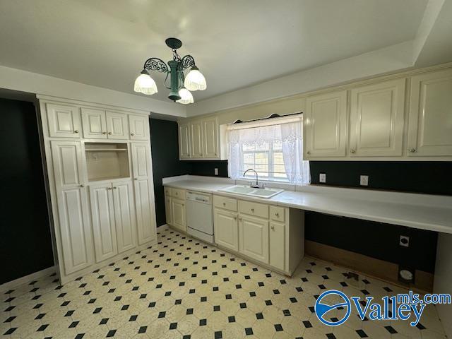 kitchen with decorative light fixtures, dishwasher, sink, a chandelier, and cream cabinetry