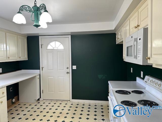 kitchen with pendant lighting, white appliances, and an inviting chandelier