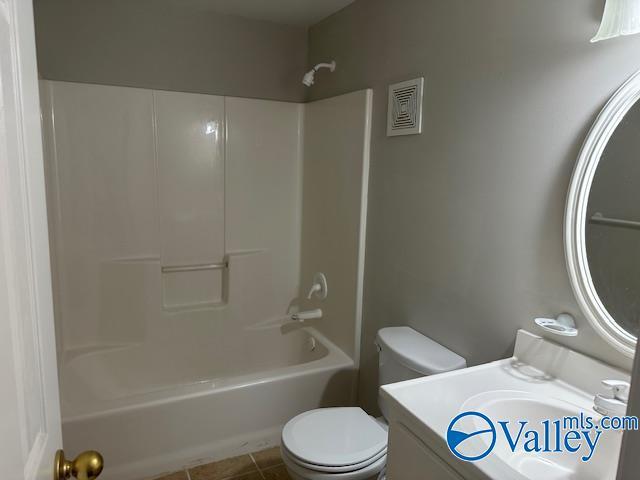full bathroom with shower / bathtub combination, vanity, toilet, and tile patterned flooring