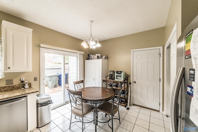 106 Spinnaker Ridge Dr, Huntsville, AL 35824 - dining area featuring light tile patterned flooring, a textured ceiling, and a notable chandelier
