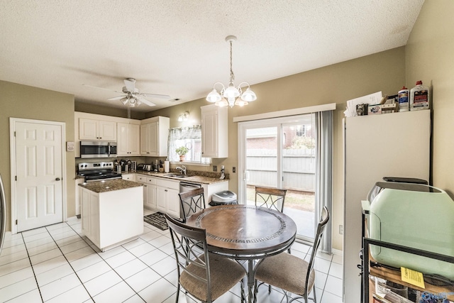 106 Spinnaker Ridge Dr, Huntsville, AL 35824 - kitchen with a center island, a sink, white cabinets, ceiling fan with notable chandelier, and stainless steel appliances