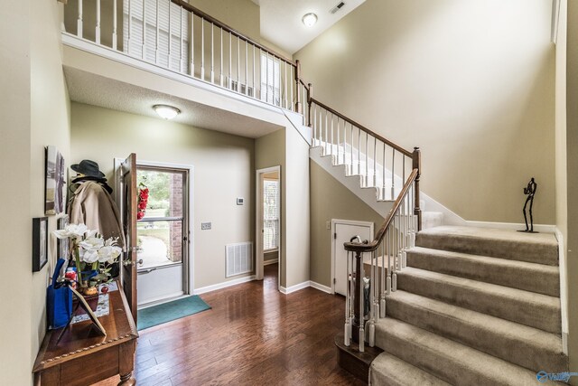 106 Spinnaker Ridge Dr, Huntsville, AL 35824 - foyer entrance with visible vents, a towering ceiling, baseboards, stairway, and dark wood-type flooring