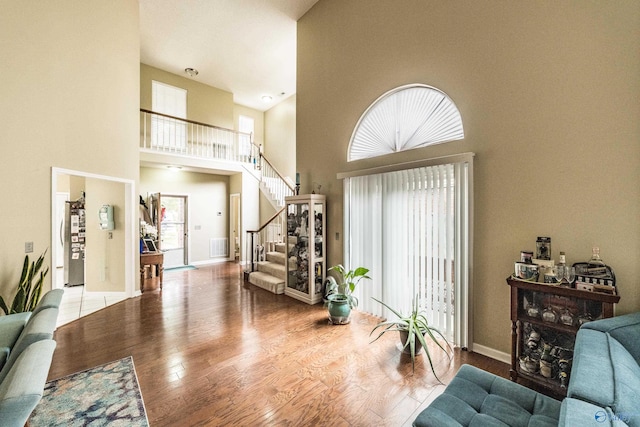 106 Spinnaker Ridge Dr, Huntsville, AL 35824 - living room with stairs, baseboards, wood finished floors, and a towering ceiling
