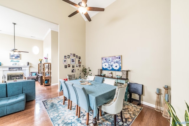 106 Spinnaker Ridge Dr, Huntsville, AL 35824 - dining area with ceiling fan, a premium fireplace, baseboards, wood finished floors, and a towering ceiling