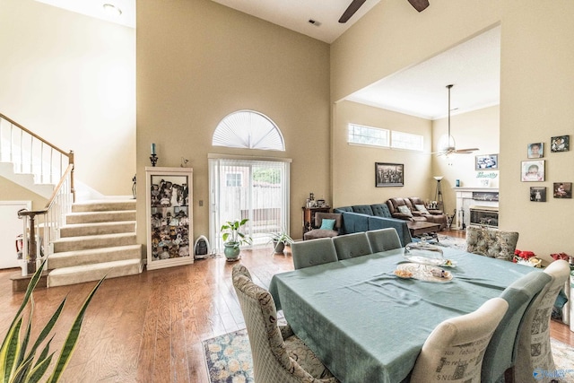 106 Spinnaker Ridge Dr, Huntsville, AL 35824 - dining space with wood finished floors, a high ceiling, stairway, a high end fireplace, and a ceiling fan