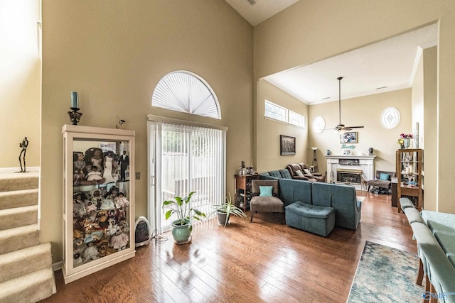 106 Spinnaker Ridge Dr, Huntsville, AL 35824 - living area with wood-type flooring, a towering ceiling, a healthy amount of sunlight, a ceiling fan, and a premium fireplace