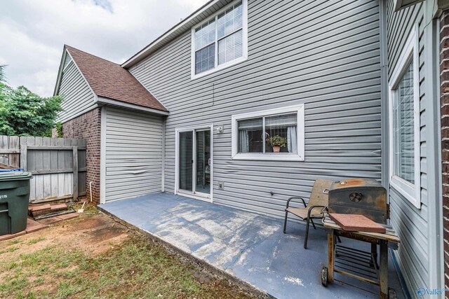 106 Spinnaker Ridge Dr, Huntsville, AL 35824 - back of property featuring fence, a patio area, and roof with shingles