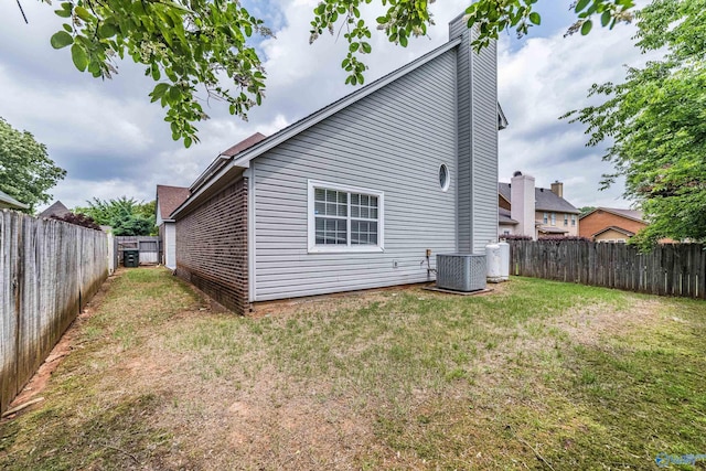 106 Spinnaker Ridge Dr, Huntsville, AL 35824 - rear view of house featuring a lawn, central AC, a chimney, and a fenced backyard