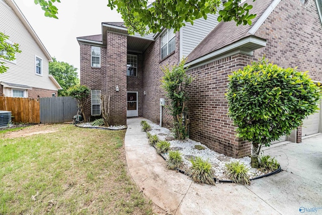 106 Spinnaker Ridge Dr, Huntsville, AL 35824 - rear view of house with a lawn, brick siding, and fence