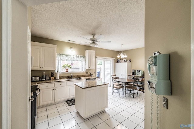 106 Spinnaker Ridge Dr, Huntsville, AL 35824 - kitchen with a kitchen island, white cabinetry, a sink, and ceiling fan with notable chandelier