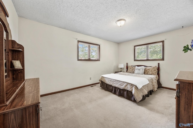 2009 Rangewood Cir, Huntsville, AL 35803 - bedroom featuring light colored carpet, a textured ceiling, and baseboards