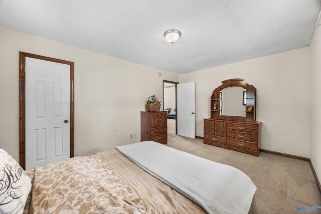 2009 Rangewood Cir, Huntsville, AL 35803 - bedroom featuring light carpet, baseboards, and a textured ceiling