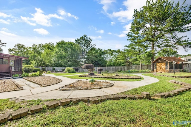 2009 Rangewood Cir, Huntsville, AL 35803 - view of yard featuring a sunroom and an outbuilding