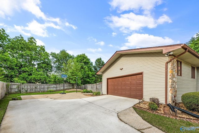 2009 Rangewood Cir, Huntsville, AL 35803 - view of side of property with a garage, driveway, and stone siding