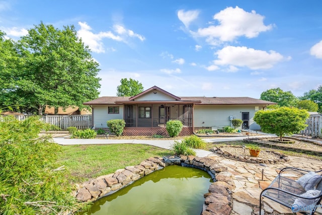 2009 Rangewood Cir, Huntsville, AL 35803 - back of property with a sunroom and a small pond