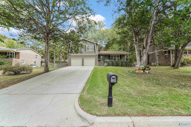 split level home with a front yard, concrete driveway, and an attached garage