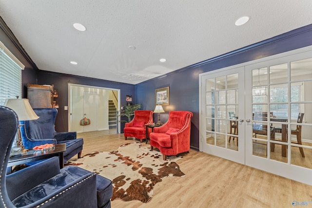 living room featuring ornamental molding, wood finished floors, a textured ceiling, french doors, and recessed lighting