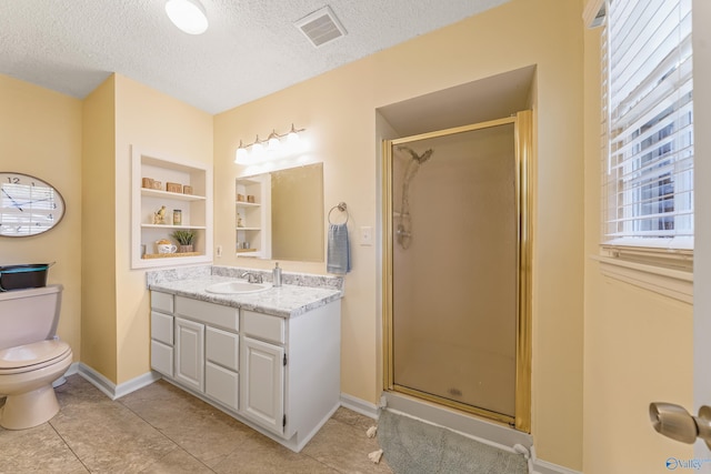 full bathroom featuring visible vents, toilet, a stall shower, a textured ceiling, and vanity