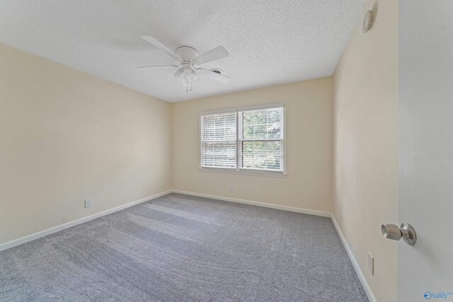 empty room featuring carpet, a textured ceiling, baseboards, and a ceiling fan