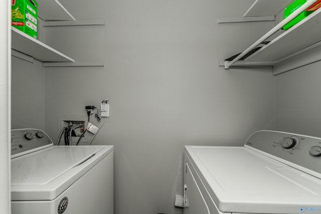 clothes washing area with laundry area and washing machine and clothes dryer