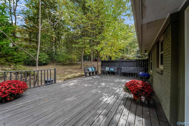 wooden deck with fence and grilling area