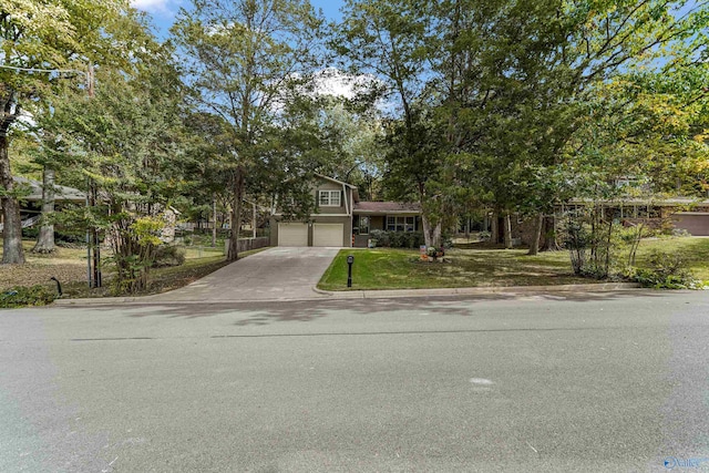 view of front of house featuring a garage, a front lawn, and concrete driveway