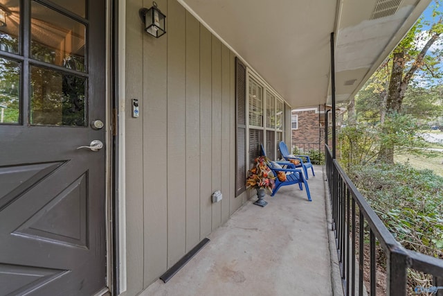 balcony featuring covered porch and visible vents