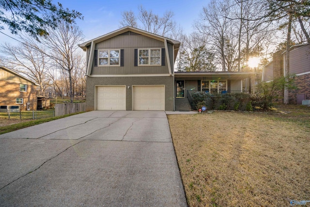 tri-level home featuring brick siding, covered porch, an attached garage, fence, and driveway