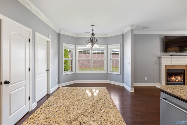 dining area featuring crown molding, a chandelier, and dark hardwood / wood-style flooring