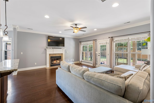 living room featuring ceiling fan, ornamental molding, and dark hardwood / wood-style floors