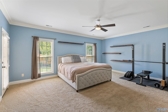 carpeted bedroom featuring crown molding and ceiling fan