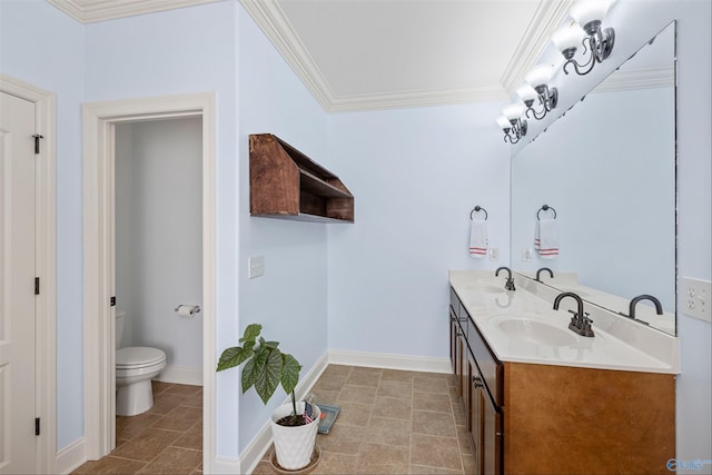 bathroom with vanity, crown molding, and toilet